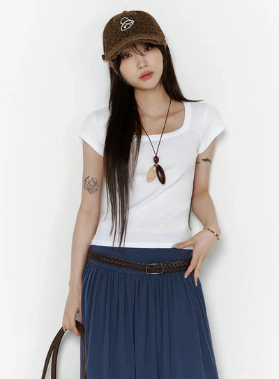 LEWKIN Square Neck Short Sleeve Tee IL502 White S/M styled front shot on model wearing leopard cap, pendant necklace, braided belt, and navy pleated maxi skirt