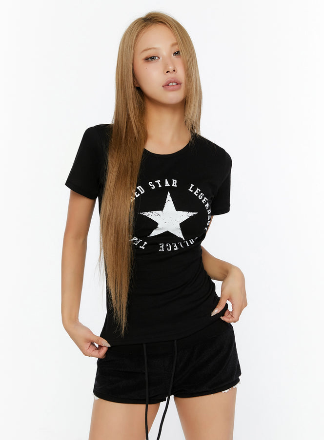 Star Graphic Slim-Fit Tee IL524 Black front shot on model with white star graphic print crew neck short sleeve slim-fit tee paired with black shorts