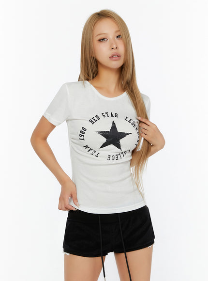 Star Graphic Slim-Fit Tee IL524 White front shot on model with one hand touching hair showcasing slim ribbed fit crew neckline and bold star graphic print