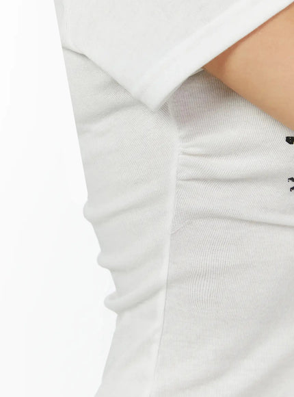 Star Graphic Slim-Fit Tee IL524 White close-up detail shot showing side seam and soft lightweight ribbed knit fabric texture with gentle stretch and form-fitting cut