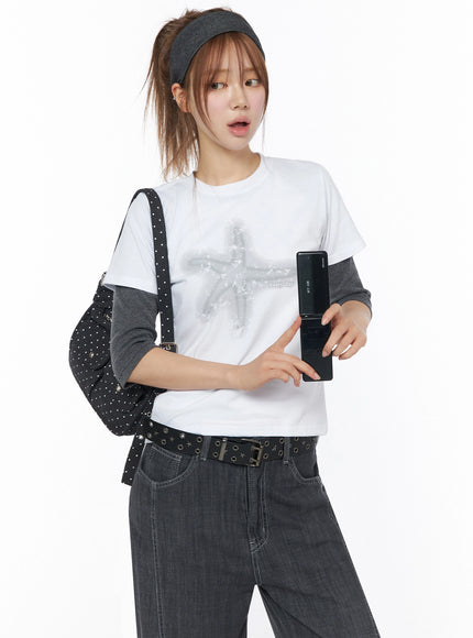LEWKIN Star Graphic Tee IU525 White S/M front model shot with star print layered over gray long-sleeve tee styled with dark jeans and studded bag