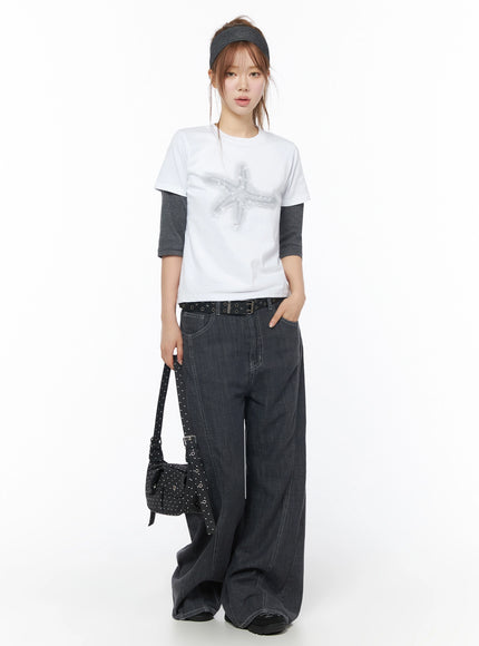 Star Graphic Tee IU525 White full-body front model shot with gray headband and studded bag layered over gray long-sleeve tee styled with wide-leg dark denim