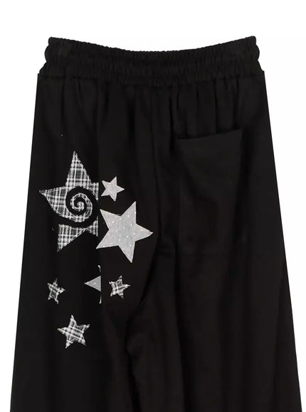 Star Graphic Wide Leg Sweatpants IL506 Black flat-lay close-up showing elastic waist and white plaid and sequin star appliqués with back patch pocket
