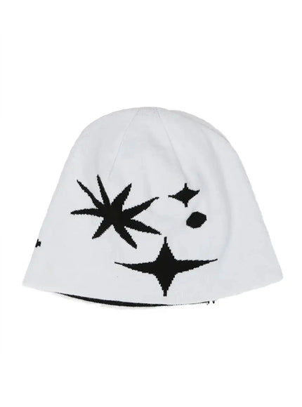 Star Knit Beanie IL506 White flat product shot, white knit beanie laid flat showing black starburst and four-point star intarsia pattern with black trim at brim