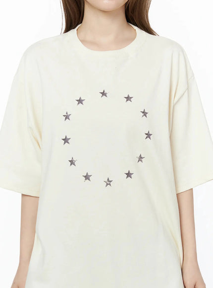 Star Ring Graphic Oversized Tee IL502 Light beige close-up front detail shot circular ring of distressed star prints on soft cotton fabric crew neckline