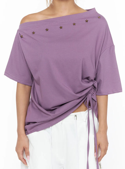 Star Studded Asymmetric Drawstring Tee CU524 Purple close-up front torso shot on model highlighting side ruched gather and drawstring tie detail with asymmetric off-shoulder neckline and star studs