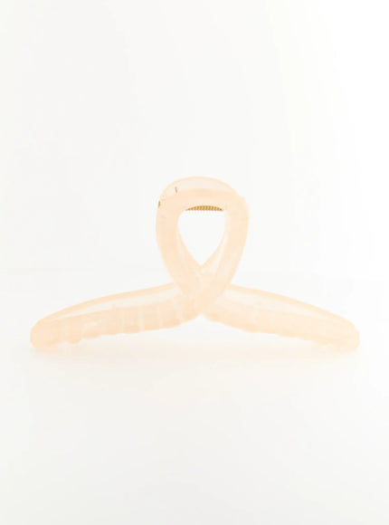 Stella Litter Hair Clip IL503 beige front view flat surface shot displaying crossed-loop top design with serrated claw teeth in translucent ivory resin