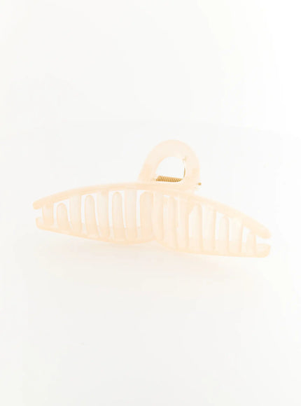 Stella Litter Hair Clip IL503 beige side shot showing elongated ribbed claw body with rounded loop handle in milky ivory translucent resin