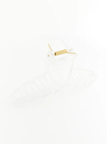 Stella Litter Hair Clip IL503 clear close-up detail shot highlighting gold coil spring and pin hinge mechanism with transparent acrylic loop handle