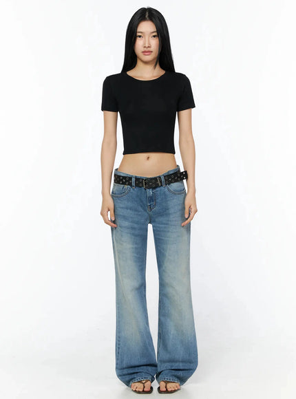 Stretch Crop Tee IL509 Black full-body front shot on model standing neutral arms at sides paired with wide-leg faded blue jeans and black eyelet belt