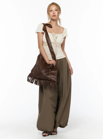 LEWKIN String Detail Parachute Pants CU524 Brown full-length front shot on model styled with cream ruched top and brown fringe bag