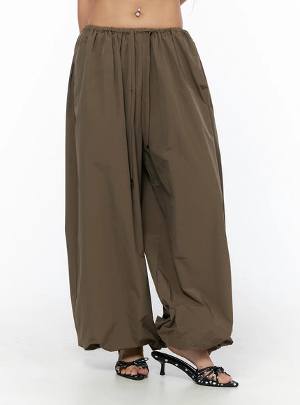 String Detail Parachute Pants CU524 Brown close-up front shot on model showing elastic drawstring waistband and wide-leg silhouette