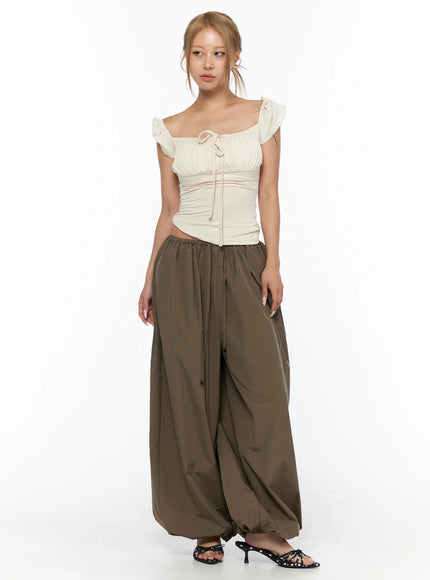 String Detail Parachute Pants CU524 Brown front full-length shot on model with cream ruffle top showing drawstring waist and balloon hem