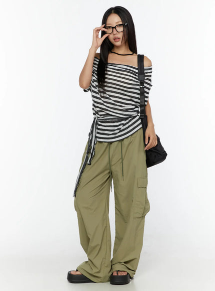 String Pocket Wide Pants CU526 Dark green full-body front shot on model styled with striped off-shoulder top, black bag and platform sandals