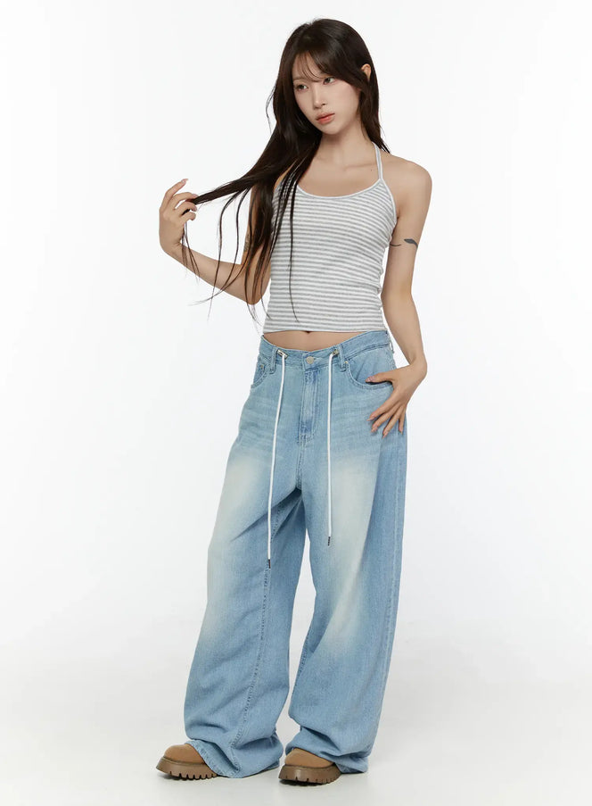 Stripe Halter Sleeveless Top CL507 Gray full-body front shot on model in S/M standing with hand in hair styled with wide-leg denim and brown chunky shoes