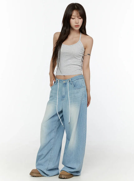 Stripe Halter Sleeveless Top CL507 Gray full-body side-angle shot on model looking down S/M cropped halter top with thin halter strap and wide-leg jeans