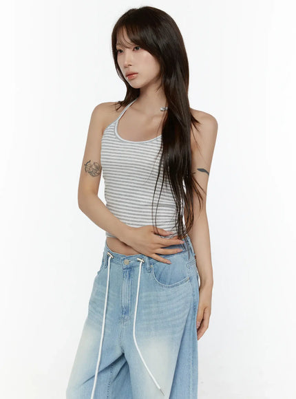 Stripe Halter Sleeveless Top CL507 Gray three-quarter side shot on model arms crossed at waist showing cropped ribbed stripe halter neck tie detail
