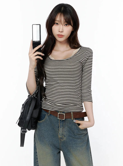 LEWKIN Striped 3/4 Long Sleeve Top IL506 Dark brown front shot on model holding flip phone, lace inner camisole visible at U-neckline, styled with wide-leg jeans and leather belt