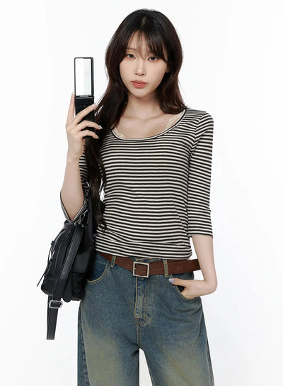 LEWKIN Striped 3/4 Long Sleeve Top IL506 Dark brown front shot on model holding flip phone, lace inner camisole visible at U-neckline, styled with wide-leg jeans and leather belt