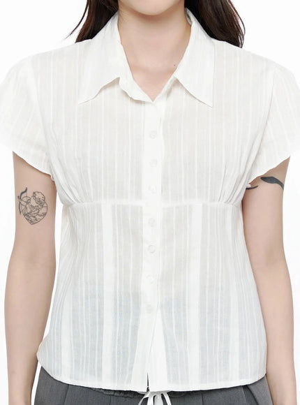Striped Button-Up Blouse IL506 White close-up front detail shot on model highlighting button placket, gathered empire waist, and semi-sheer striped fabric texture
