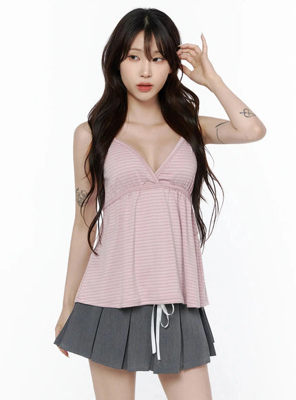Striped Cami Tank Top IL506 Pink front shot on standing model with deep V-neck wrap bust, flared silhouette, paired with gray pleated mini skirt