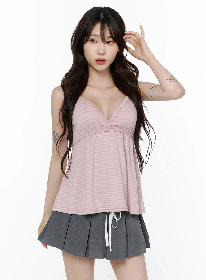Striped Cami Tank Top IL506 Pink front shot on standing model with deep V-neck wrap bust, flared silhouette, paired with gray pleated mini skirt