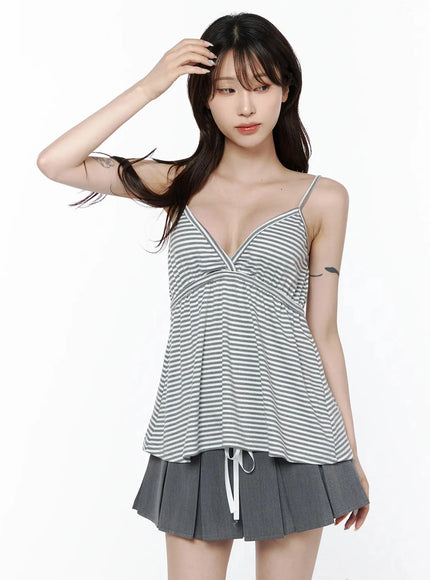 Striped Cami Tank Top IL506 Gray cropped front shot on model with hand in hair, showing V-neck wrap bust and flared body over gray pleated skirt
