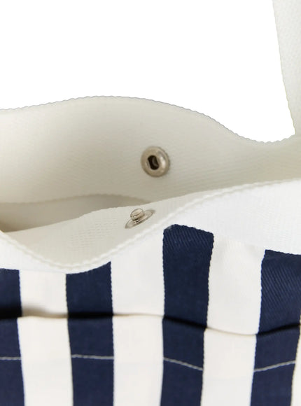 Striped Canvas Tote Bag IL514 Dark blue close-up interior detail showing silver snap button closure and white canvas lining with navy stripe exterior fabric texture