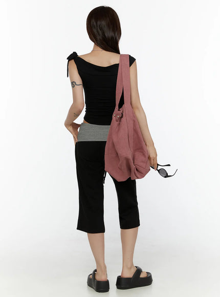 Striped Capri Pants CL508 Black back full-body shot on model styled with black tie-shoulder top and pink crossbody bag holding sunglasses