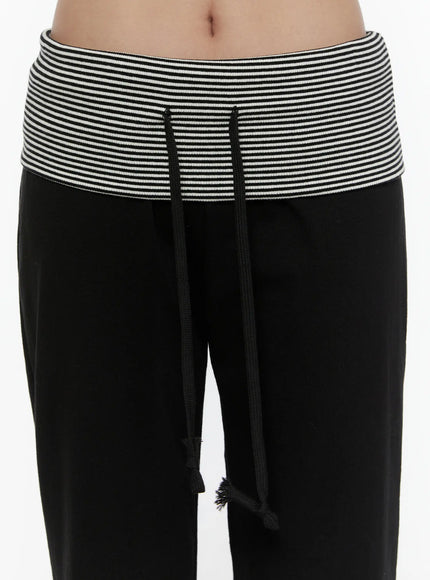 Striped Capri Pants CL508 Black close-up detail of striped ribbed waistband with black drawstring cord on model