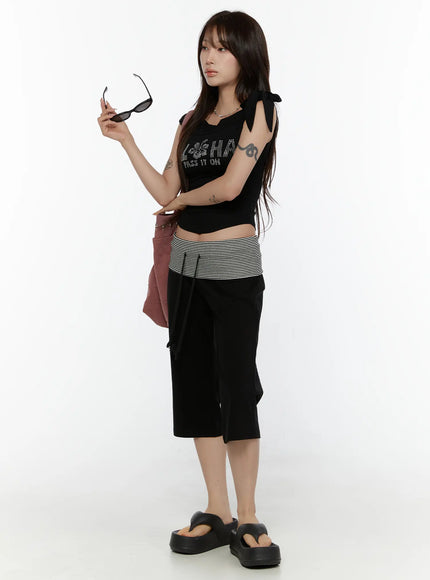 Striped Capri Pants CL508 Black three-quarter front shot on model holding sunglasses with pink bag styled with black crop top