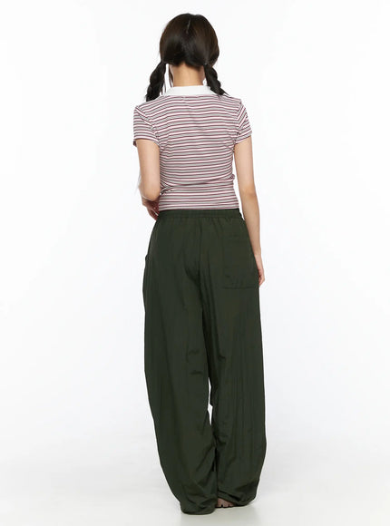 Striped Collared Crop Top Tee CL514 Pink back shot on model showing short-sleeve crop fit and horizontal stripe pattern, back view with dark green wide-leg trousers