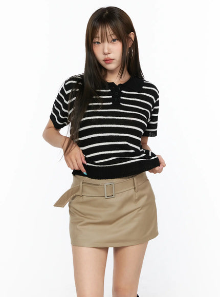 LEWKIN Striped Collared Knit Short Sleeve Top CL514 Black S/M front shot on model wearing khaki belted mini skirt, textured stripe knit polo