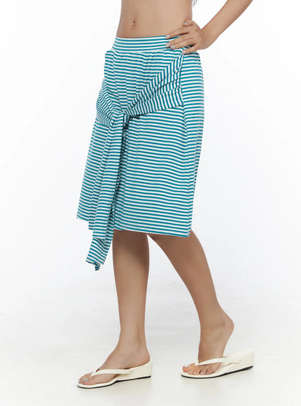 Striped Front-Tie Midi Skirt CL513 Blue side view on model walking pose styled with white tee beige bag and flip flops showing skirt silhouette