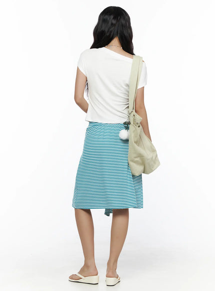 Striped Front-Tie Midi Skirt CL513 Blue back full-length on model styled with white tee and beige pom-pom bag showing back skirt panel and hem