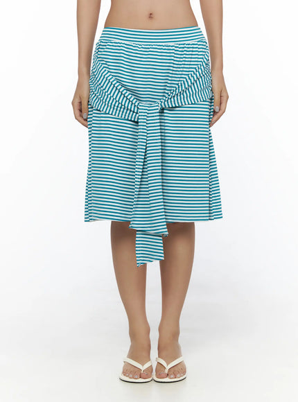 Striped Front-Tie Midi Skirt CL513 Blue front full-length on model with arms relaxed showing front tie detail teal white stripe midi length and flip flops
