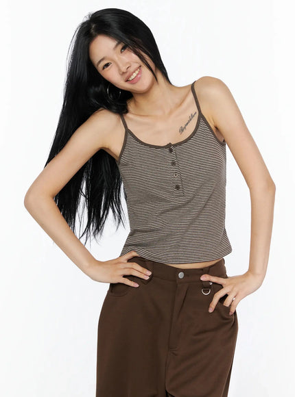 Striped Henley Tank Top IL509 Brown front smiling model shot, hands on hips, cropped cami silhouette with center button detail and stripe ribbed fabric