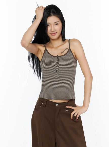 Striped Henley Tank Top IL509 Brown three-quarter front model shot, hand in hair, smiling, showing brown-stripe cropped cami with button front detail