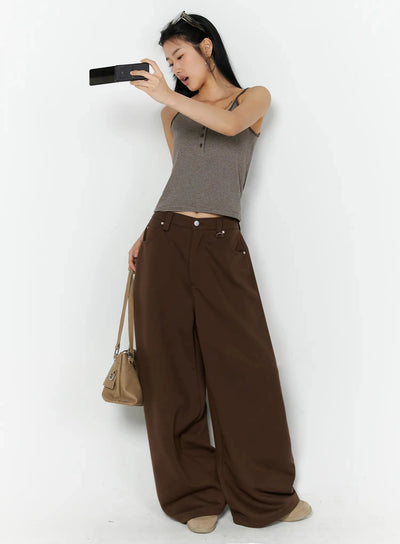 LEWKIN Striped Henley Tank Top IL509 Brown S/M full-body lifestyle shot on model holding phone, paired with wide-leg brown trousers and beige bag