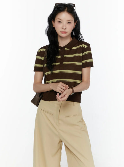 LEWKIN Striped Knit Polo Top CL520 Dark brown front shot on model size S/M hands clasped styled with beige wide-leg trousers and brown shoulder bag