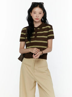 LEWKIN Striped Knit Polo Top CL520 Dark brown front shot on model size S/M hands clasped styled with beige wide-leg trousers and brown shoulder bag