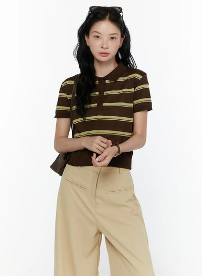 LEWKIN Striped Knit Polo Top CL520 Dark brown front shot on model size S/M hands clasped styled with beige wide-leg trousers and brown shoulder bag