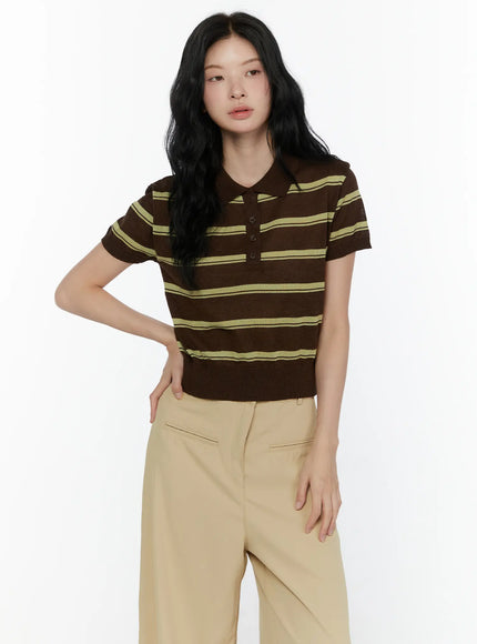 Striped Knit Polo Top CL520 Dark brown front close-up on model hand on hip showing yellow-green horizontal stripes polo collar and button placket knit texture