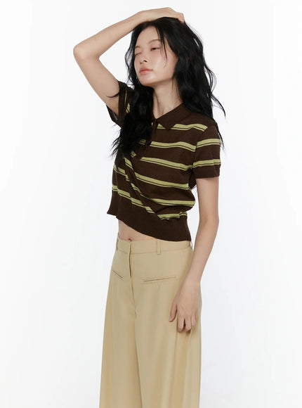 Striped Knit Polo Top CL520 Dark brown three-quarter side shot on model arm raised showing cropped silhouette yellow-green stripes and short sleeve knit construction