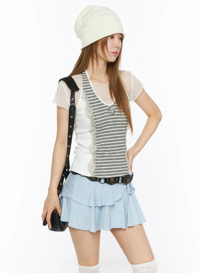 LEWKIN Striped Lace Trim Tank Top CL501 Beige S/M front three-quarter model shot layered over sheer tee with striped lace trim vest styled with light blue ruffle mini skirt and beanie