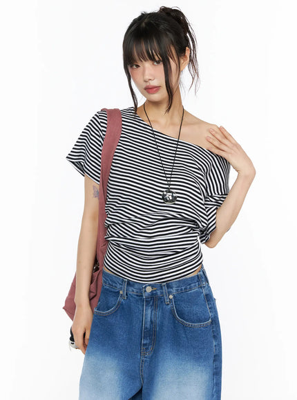 LEWKIN Striped Off-Shoulder Top CU530 Black S/M front shot on model styled with blue jeans and pink shoulder bag, one-shoulder stripe knit top