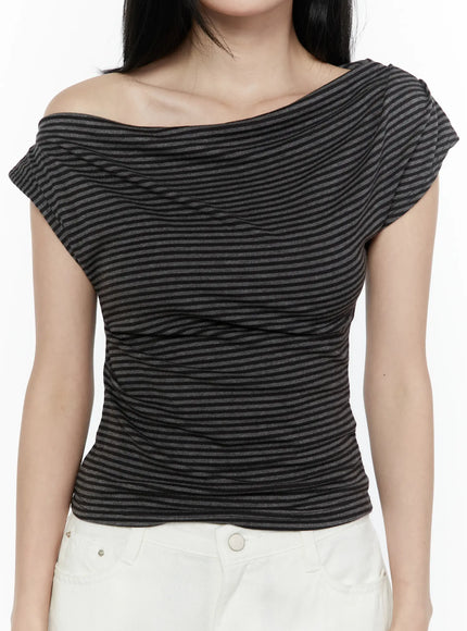 Striped Off-Shoulder Top IL506 Dark gray close-up front model shot highlighting asymmetric draped neckline and ruched striped knit texture