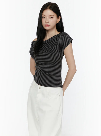Striped Off-Shoulder Top IL506 Dark gray three-quarter front model shot with hands in pocket showing twisted neckline drape detail