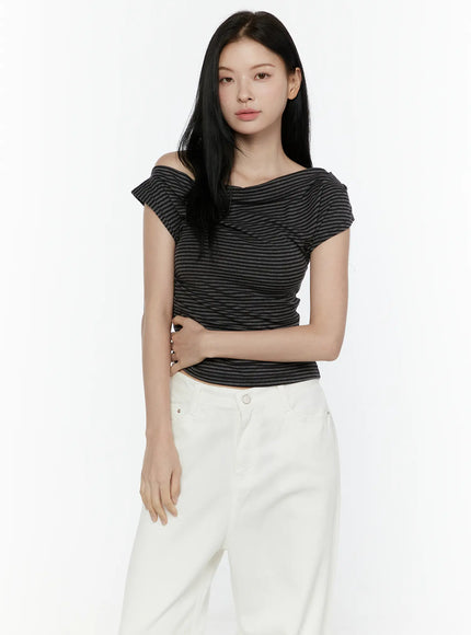 Striped Off-Shoulder Top IL506 Dark gray half-body front model shot with arm crossed at waist showing ruched texture and asymmetric neckline