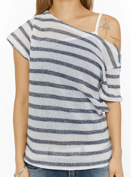 Striped Off-Shoulder Top IL524 Dark blue close-up detail shot on model highlighting asymmetric off-shoulder neckline open-knit stripe texture and exposed shoulder